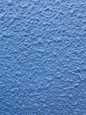 Render coating work on property exterior